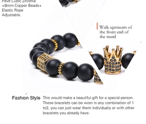Macro shot of 8mm black matte stone beads and gold crown charm with AAA zircons