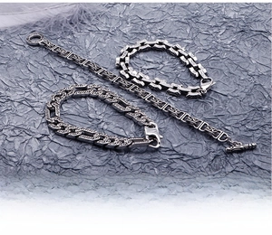 Detail of vintage silver stainless steel bracelets with intricate engraved floral patterns