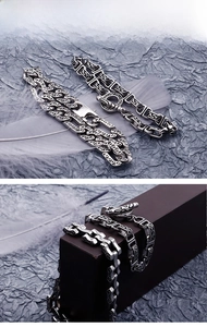 Detailed macro of vintage stainless steel bracelets with Gothic carvings and T-bar toggle