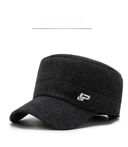 Detail of dark grey winter flat cap with thick fleece texture and silver metal logo