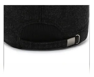 Detail of adjustable metal buckle and grey textured fabric on men winter hat back