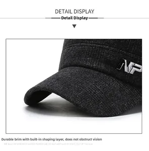 Detailed macro view of the solid brim and silver NP metal logo on men's winter cap