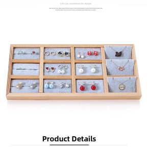 Detail of 12-slot wooden jewelry tray with blue velvet lining for rings and necklaces