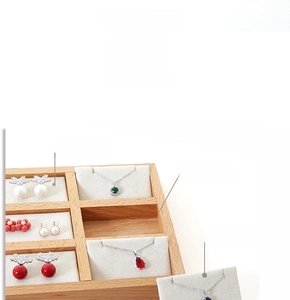 Close-up of beech wood jewelry tray with 12 slots for earrings and necklaces display