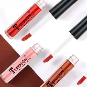 Detailed macro view of three matte lip gloss applicators and rectangular bottles
