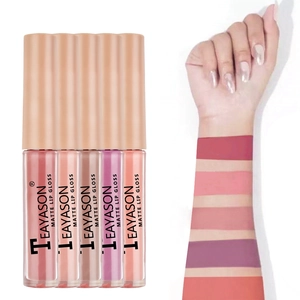 Arm swatches of five matte lip gloss shades including nude and coral on white background