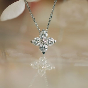 Macro shot of a four-leaf clover necklace pendant with sparkling cubic zirconia in 14K gold