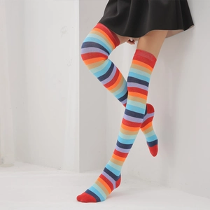 Close-up of rainbow striped over-the-knee socks showing knit texture and elastic fit