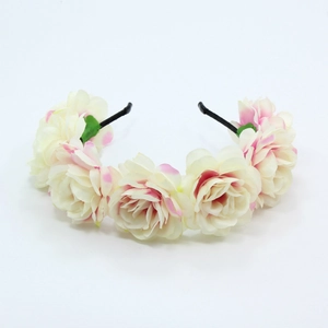 Detail of handmade white fabric roses with pink edges on a black bridal floral headband