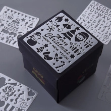 DIY painting stencils with Christmas patterns and letters in a black square gift box