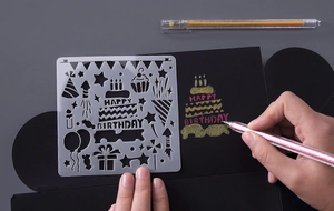 Macro view of translucent PET stencil showing Happy Birthday patterns for DIY albums
