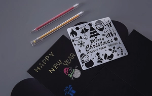Detail of Christmas drawing stencil set with Merry Christmas text on black cardstock