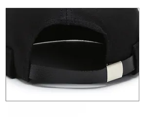 Detail of black brimless docker hat showing adjustable leather strap and silver buckle