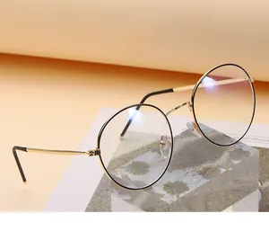 Detailed macro of gold metal round eyeglass frame with premium hinge construction