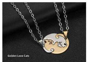Detail of interlocking gold and silver cat pendants on matching couple necklaces