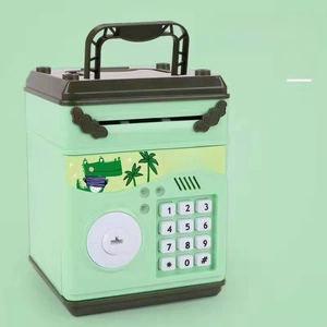 Detail view of mint green kids ATM bank with digital keypad and cute crocodile stickers