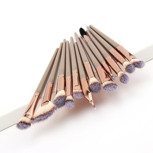 Detail view of 14 professional makeup brushes with rose gold ferrules in a fan layout