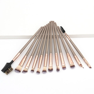 Detail view of 12 professional makeup brushes with light brown handles and rose gold ferrules