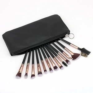 Detailed set of 15 makeup brushes with rose gold ferrules and black leather storage case