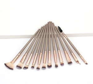 Macro shot of 13 champagne gold makeup brushes set with soft bicolor fiber bristles