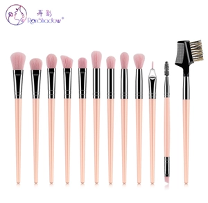Detail view of 12pcs makeup brush set with pink handles and silver ferrules on white background