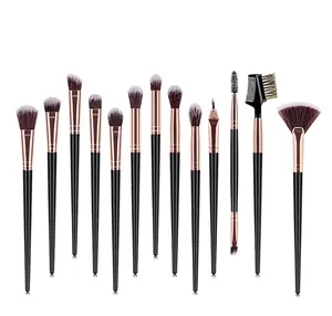 Macro view of 13 professional makeup brushes with rose gold ferrules and bicolor bristles