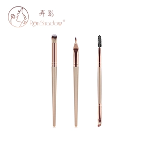 Detailed set of champagne gold eye and brow brushes with fiber bristles on white background