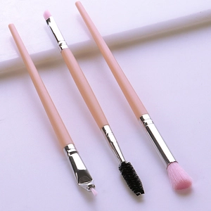 Detailed view of pink makeup brushes including eyeliner, eyebrow, and blending brush