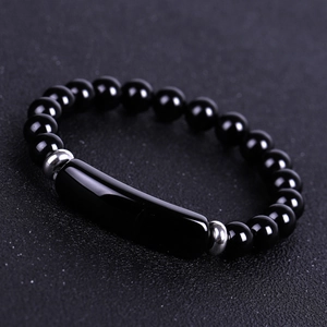 Detailed close-up of a minimalist black beaded bracelet with sleek center bar and silver spacers