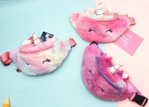 Detailed view of plush unicorn waist bags in gradient pink and purple with shiny silver horns