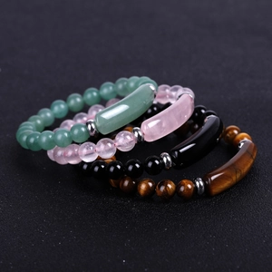 Detailed macro view of natural stone bead bracelets with smooth curved tube bar accents