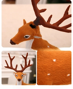 Detail of life-size orange plush reindeer featuring antler assembly and soft texture