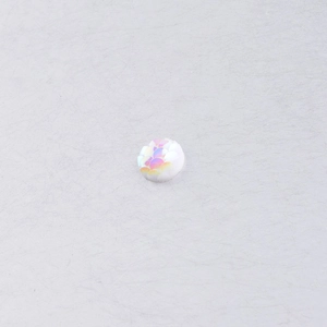 Macro detail of 8mm white fish scale resin cabochon with iridescent AB finish for DIY
