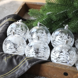 Set of 6 clear Christmas balls with white snow landscape patterns on wooden tray