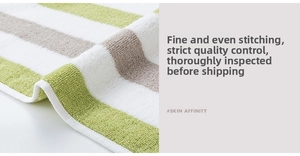 Close-up of thick cotton towel showing reinforced edge stitching and striped loop texture