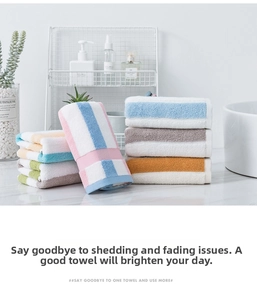 Detailed texture of thick striped cotton towels in pastel colors on marble surface