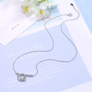 Minimalist silver planet and star pendant necklace with zircon stones on a fine link chain