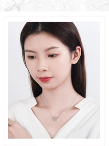 Close-up of Saturn planet pendant necklace with sparkling crystals on female model neck