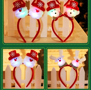 Close-up of LED glowing Christmas headbands with Santa, reindeer and tree designs