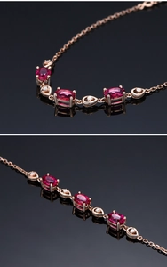 Detail of rose gold bracelet featuring red oval gemstones and white diamond teardrops