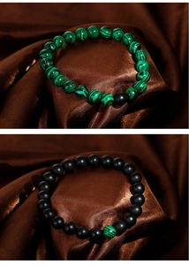 Detail of peacock green malachite style and matte black onyx beads on elastic bracelets