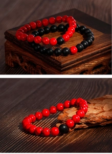 Detailed macro of 8mm matte black onyx beads and marbled red stone beaded bracelets