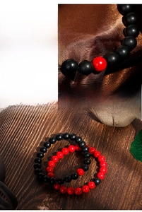 Detail of 8mm matte black agate and red cracked bead elastic beaded bracelets for couples