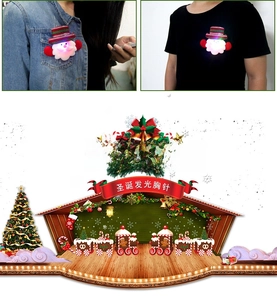 Detailed view of LED glowing Santa Claus brooch pinned on a denim jacket for Christmas