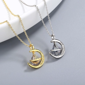 Minimalist moon pendant necklaces in gold and silver with cubic zirconia and clear beads
