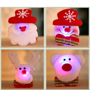 Close-up of four LED Christmas badges including Santa, Snowman, Reindeer, and Bear