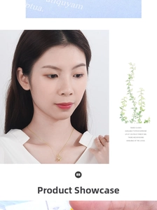 Detail of a crescent moon gold pendant necklace with a white zircon on a model collarbone