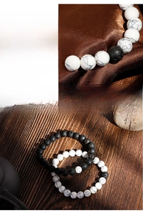 Macro shot of white marble and black lava stone beads with natural texture details
