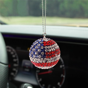 Detail of crystal ball car mirror pendant with red, white, and blue American flag rhinestones