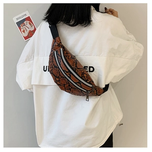 Brown faux leather snakeskin waist bag with dual zippers shown on model from behind
